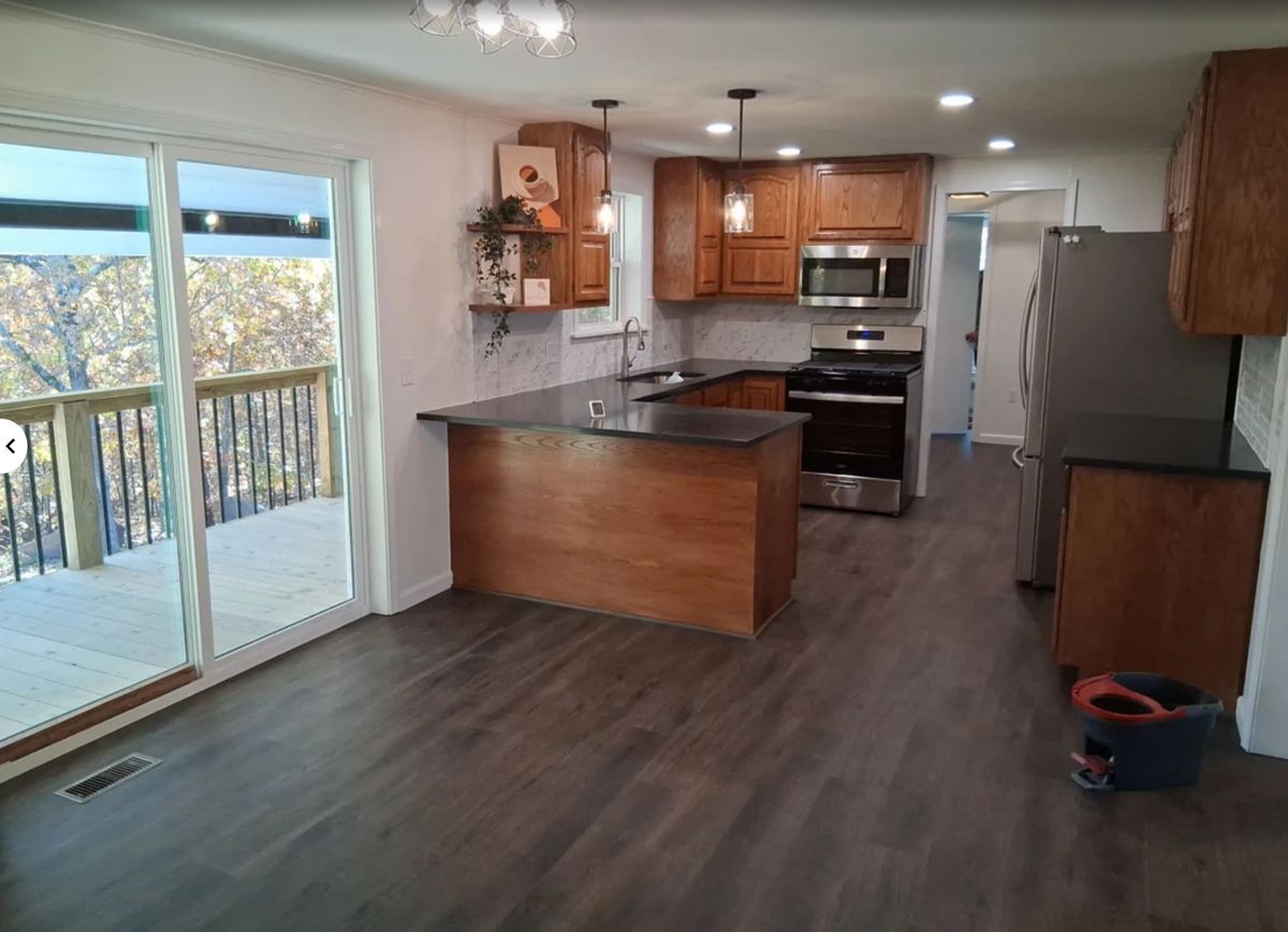 Completed kitchen remodel with wood cabinets, stone counters and new flooring